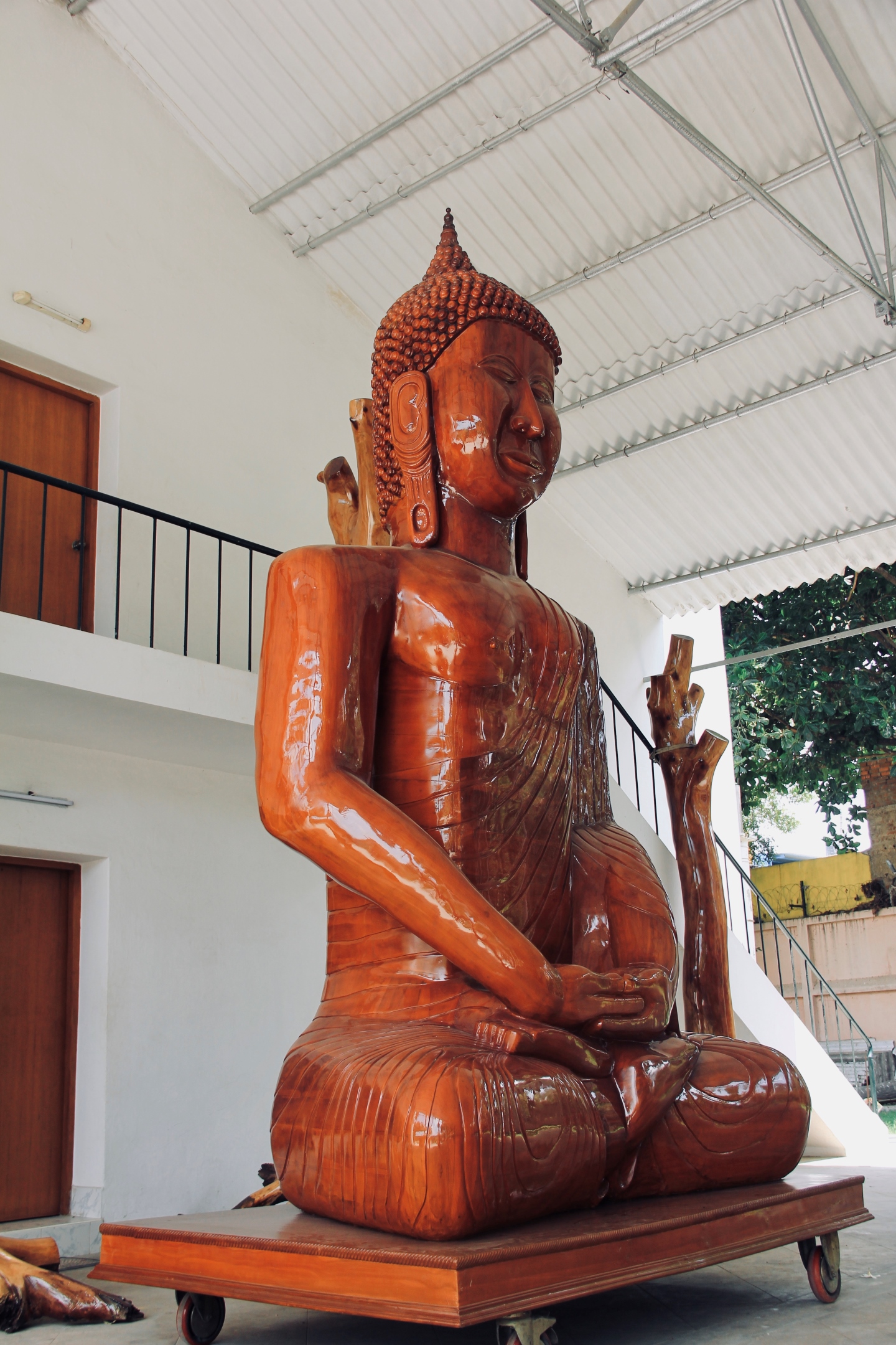 Close-up of a smiling wooden Buddha sculpture